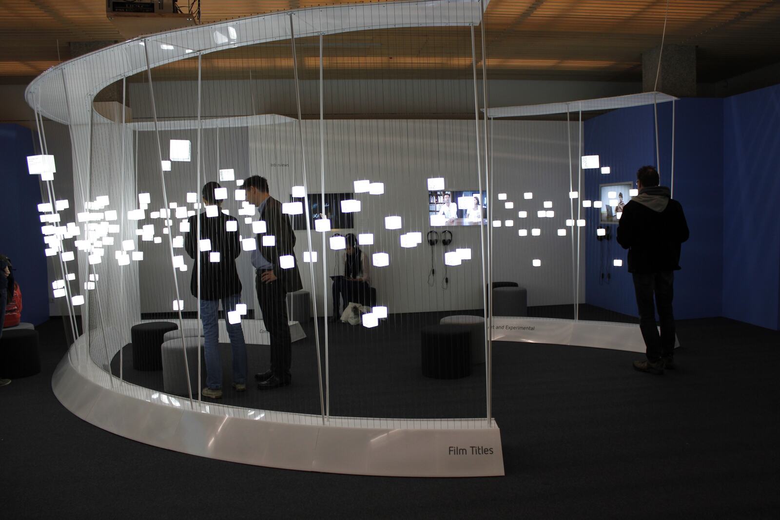 Moving Types &mdash; glowing QR cubes on tensioned wires in the media lounge of the Gutenberg-Museum Mainz
