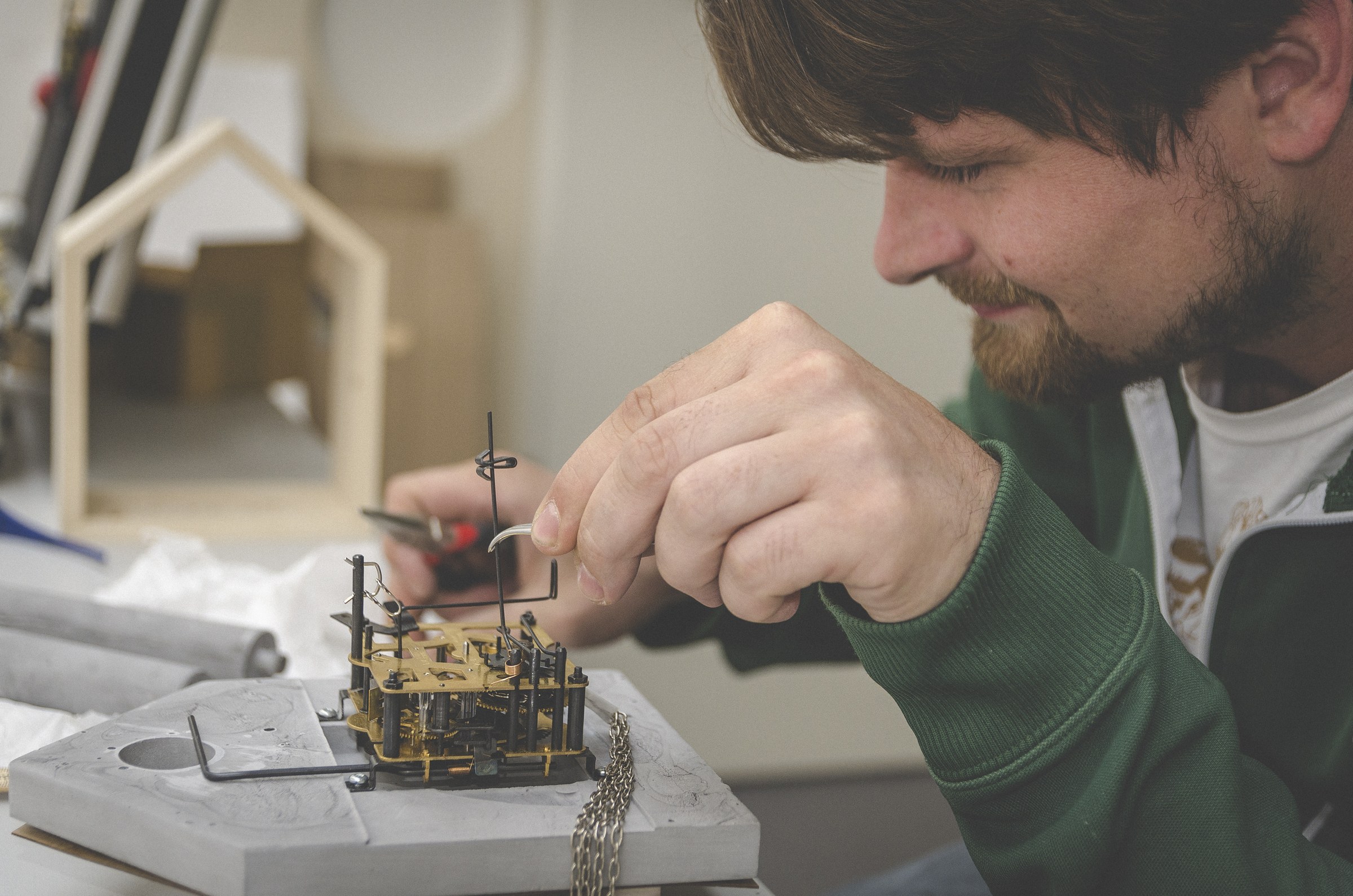 A craftsperson assembling Brunhilde's clock mechanism